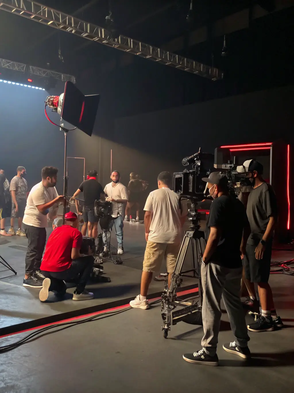 A group of people of different ages are participating in a theater workshop, rehearsing a scene with enthusiasm and laughter, showcasing the intergenerational exchange and collaborative spirit of LES PRESQUE.